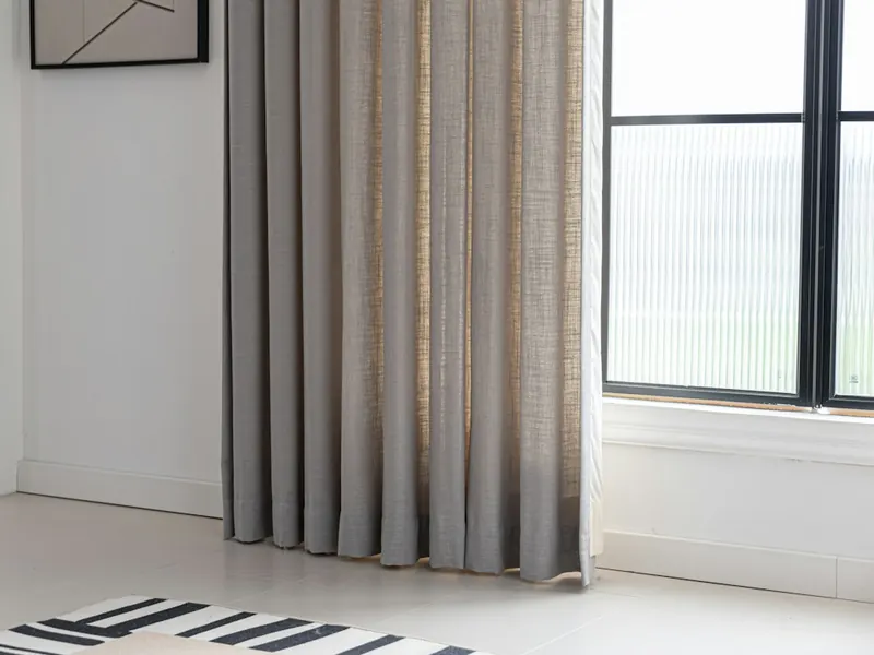 Floor-length curtains beside a window
