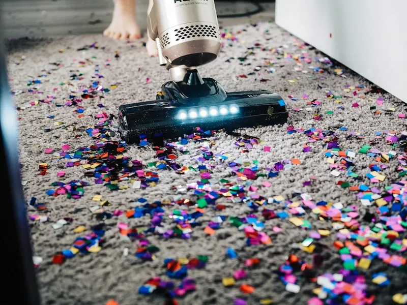 Vacuum lifting debris from a carpet